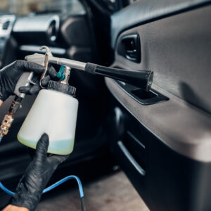 carwash-service-male-worker-in-gloves-using-spray-2024-11-26-16-03-59-utc